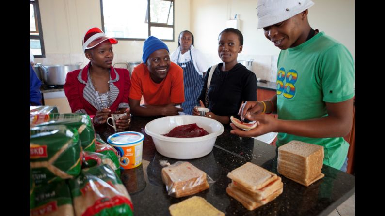 Madondo spends time with volunteers who prepare food for children in the program. The organization opens the doors to its headquarters every weekday at 7 a.m. to hand out sandwiches for students to take to school. 