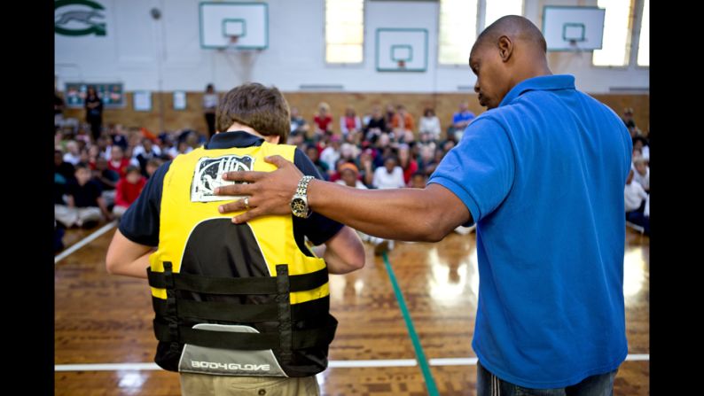 Children at the Gesu School learn how to put on a life jacket. "As a child, I never went around water," Butts said. "I never went swimming. I didn't know anything about water or life jackets and water safety."