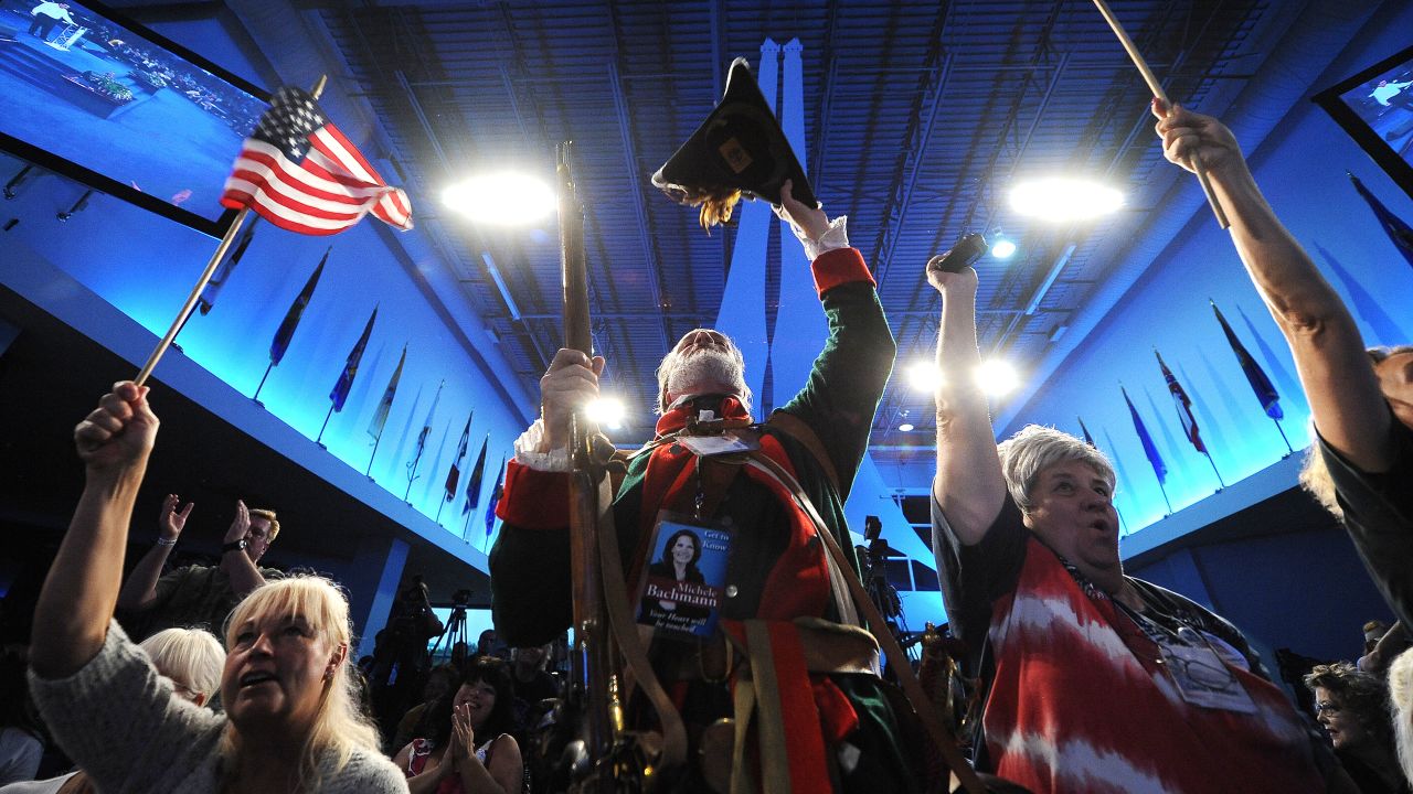 William Temple (C), in colonial dress, and other Tea Party supporters cheer at the Tea Party Unity Rally at The River at Tampa Bay Church ahead of the Republican National Convention, in Tampa, Florida, on August 26, 2012. AFP PHOTO / ROBYN BECK (Photo credit should read ROBYN BECK/AFP/GettyImages)