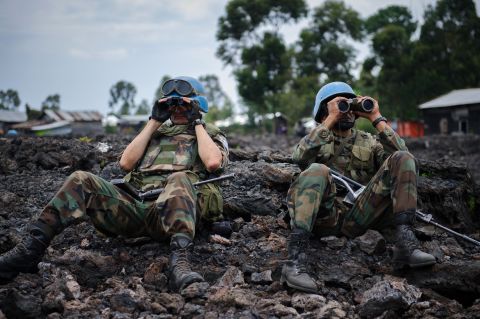 Uruguayan United Nations peacekeepers look through binoculars at M23 rebel positions on the outskirts of Goma.