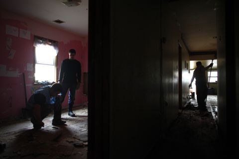 Volunteers on Tuesday remove flooring from a Keansburg, New Jersey, home damaged by the storm.