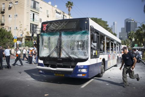 Emergency services personnel work at the scene of an explosion on a bus Wednesday in Tel Aviv, Israel. The blast on the public transport bus left at least 22 injured, a hospital official said. 