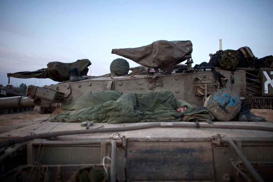 An Israeli soldier sleeps in a deployment area Wednesday on Israel's border with Gaza.