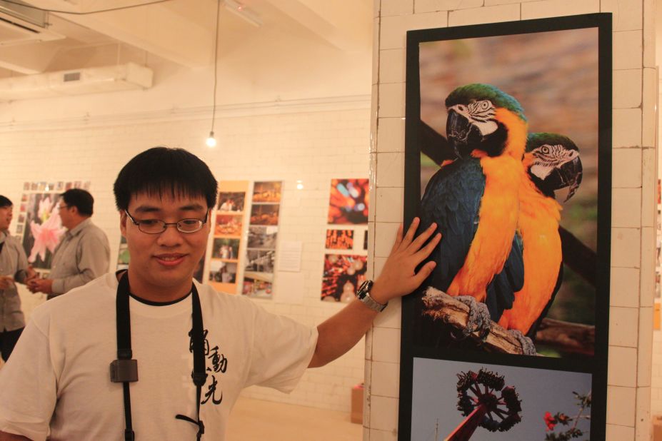 Peter Yim, who is partially blind, shows a photo he took on Hong Kong's Lamma Island, which was part of the "Luminance Touched" exhibition in early November 2012. 