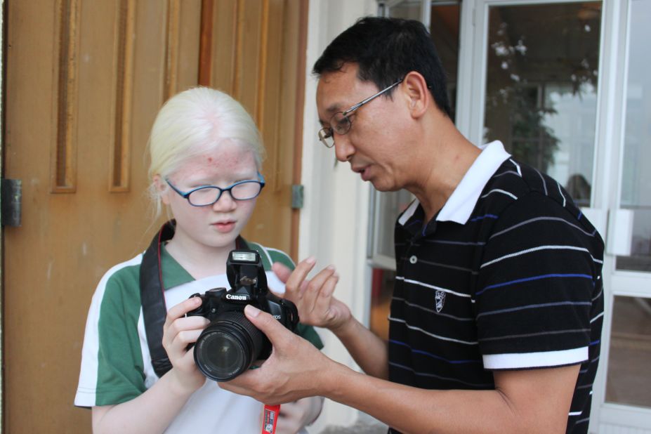 Ben Fong, a photography instructor at Ebenezer School, guides his student Eli Tang.