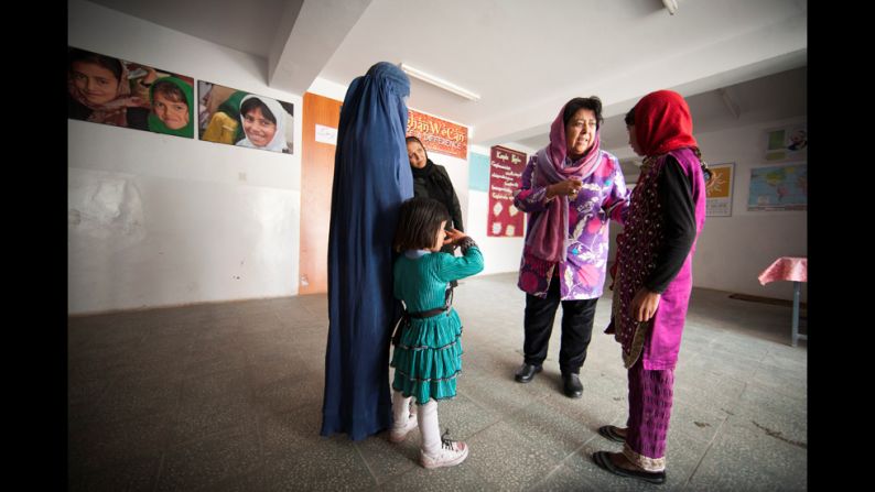 Jan welcomes a new student, right, to the school. It costs $300 to teach each girl for an entire year, but all the fees are covered by donations to Jan's nonprofit, Razia's Ray of Hope.