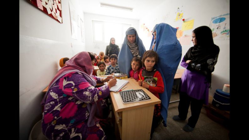 Jan registers two young girls for the start of the next school year. She said she will have to refuse some girls next year, however, as she doesn't have enough classrooms and teachers.