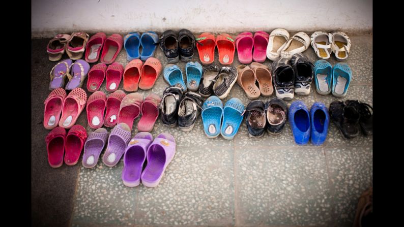 The girls have to take off their shoes before entering their classroom.