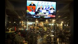 Israeli soldiers sit in a restaurant at the Yad Mordechay Junction as they watch Israeli Prime Minister Benjamin Netanyahu delivering a statement live on television from his Jerusalem office on November 21, 2012. Israel and Hamas agreed on a truce that will take effect this evening in a bid to end a week of bloodshed in and around Gaza that has killed more than 150 people, Egypt and the United States said.