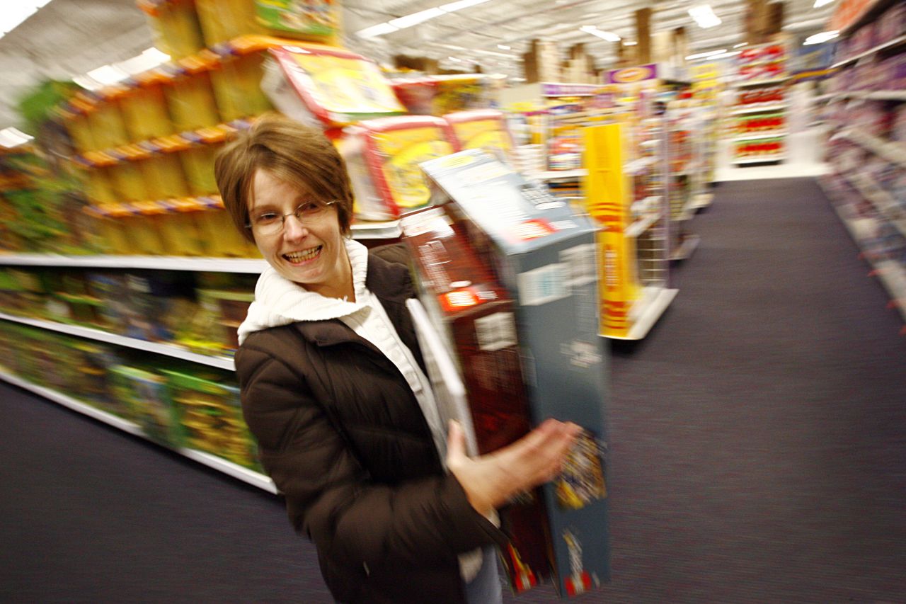 Racing through the isles of a Fort Worth, Texas, Toys'R'Us, Shawna Jones shops off her 2009 Black Friday list.