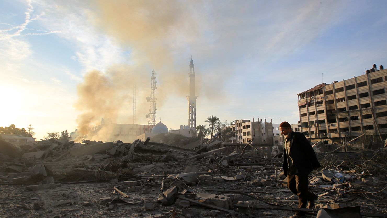 A Palestinian man walks amidst debris at the destroyed compound of the the internal security ministry in Gaza