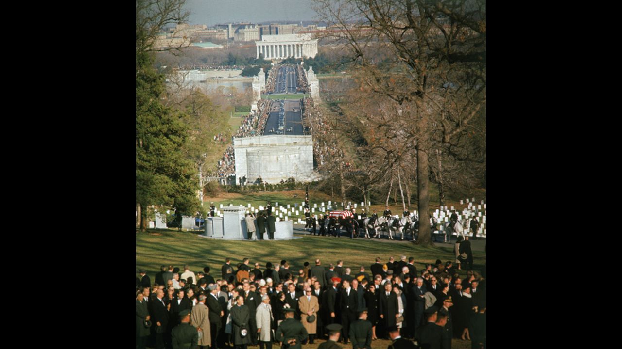 A horse-drawn caisson bears the body of President John F. Kennedy into Arlington National Cemetery.