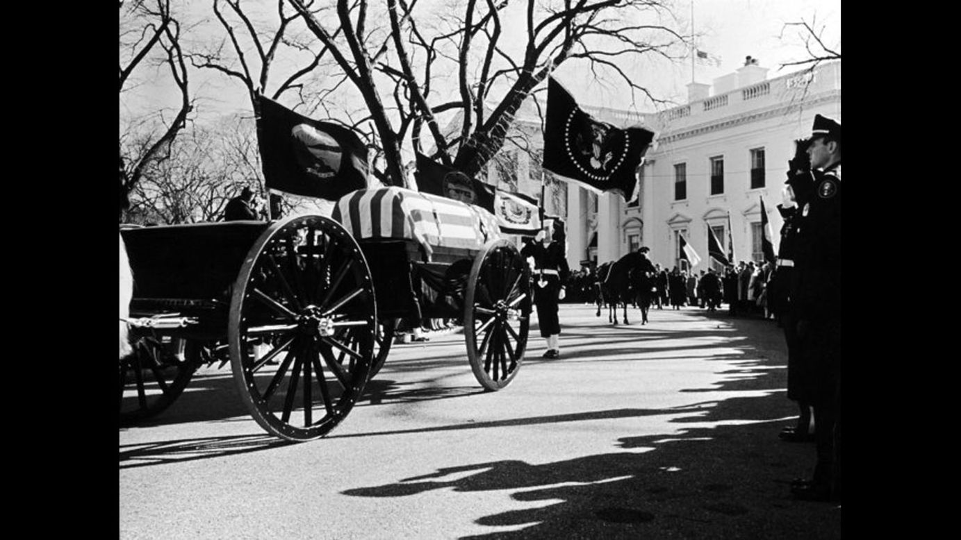 John F. Kennedy's flag-draped casket lies in state in Washington.