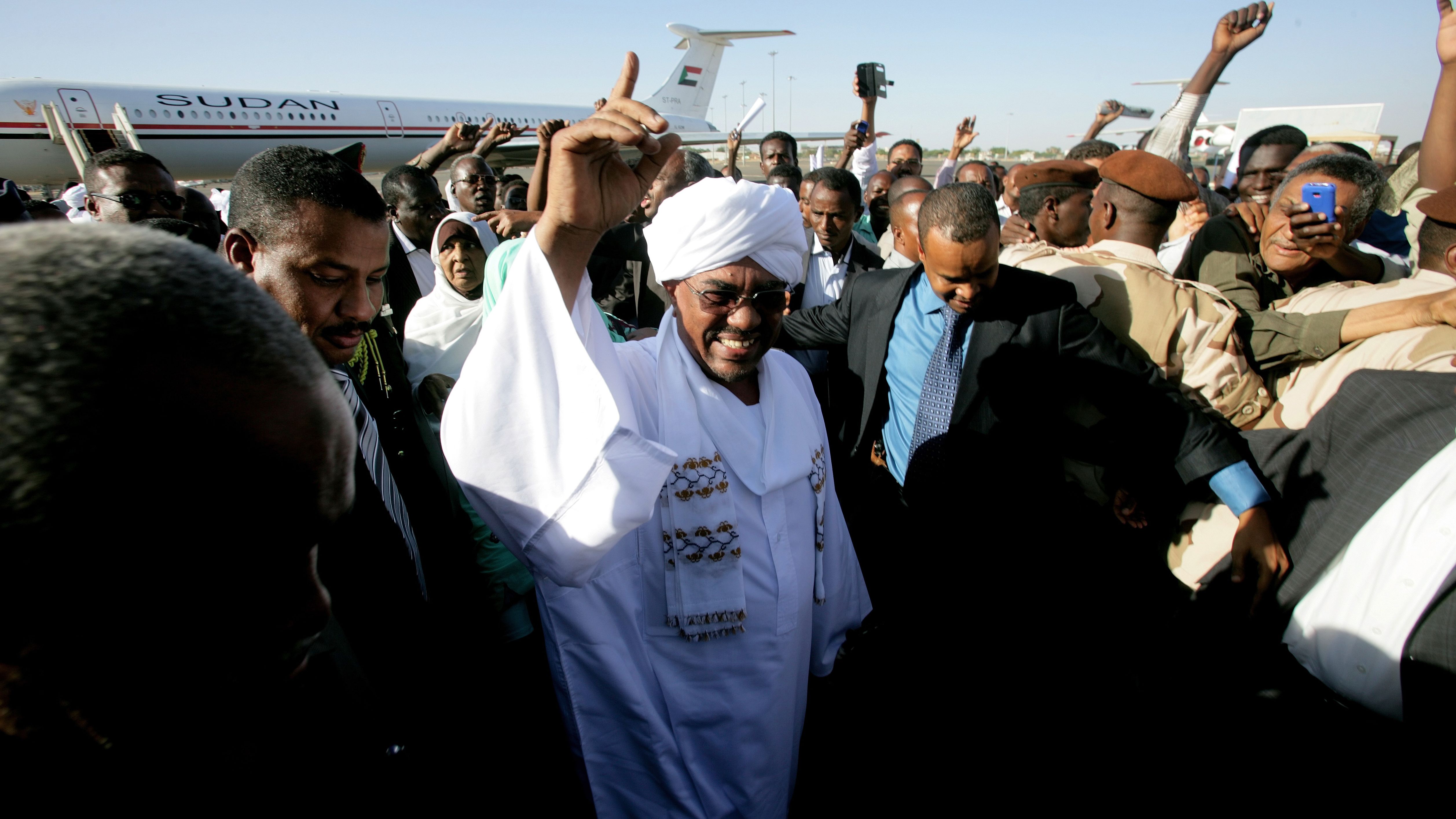 (File photo) Sudanese President Omar al-Bashir gestures as he arrives at Khartoum airport on November 14, 2012.