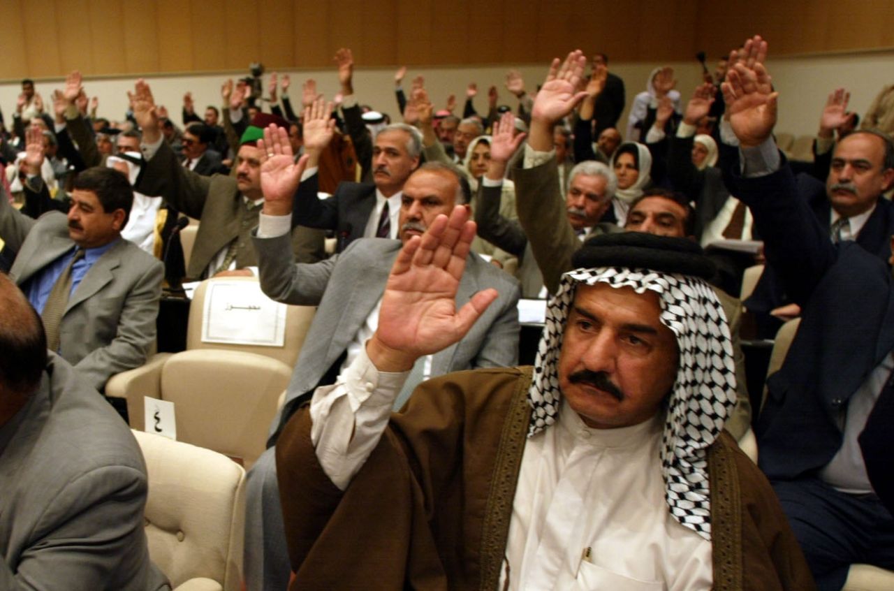 Members of Iraq's parliament vote in 2002. Luxurious mustaches became ubiquitous during Saddam Hussein's rule, but have been seen as a symbol of high social status since Ottoman times.