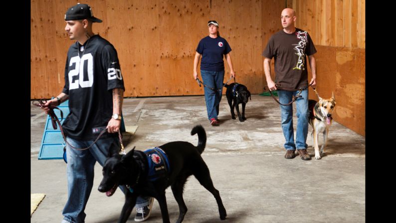 "Sometimes these vets need the help and care of a friend," photographer Benjamin Lowy said. "These service animals ... can help them get through their day."