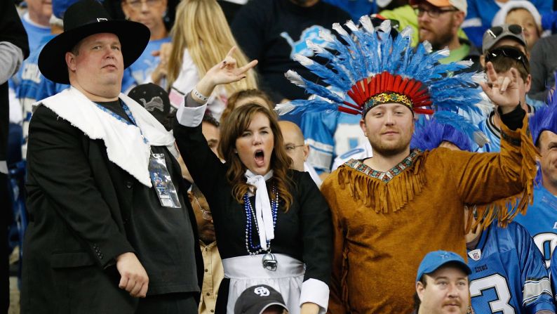 Fans dressed as pilgrims and Native Americans cheer during the Thanksgiving Day game between the Detroit Lions and the Houston Texans.