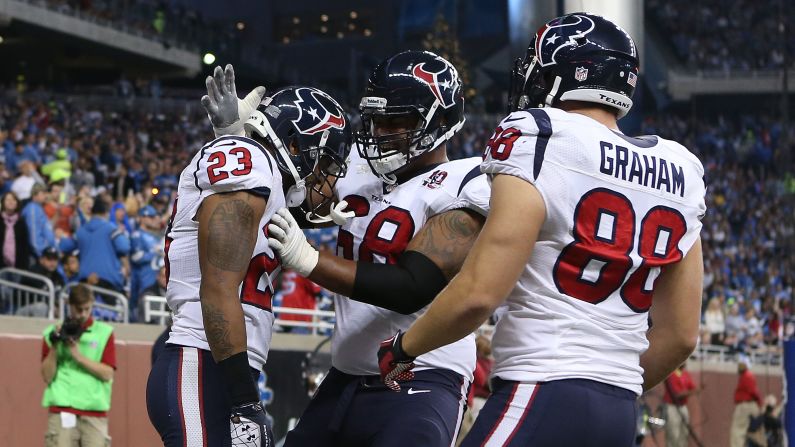 Foster, left, celebrates with teammates Ryan Harris, center, and Garrett Graham after scoring against the Detroit Lions.