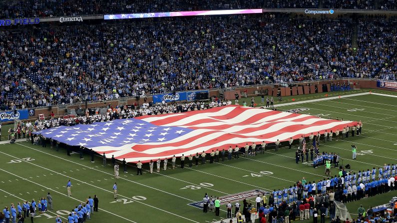 An American flag is unfurled at Ford Field before the Texans-Lions game on Thursday in Detroit. <a href="index.php?page=&url=http%3A%2F%2Fwww.cnn.com%2F2012%2F11%2F16%2Fworldsport%2Fgallery%2Fnfl-week-11%2Findex.html">Look back at the best photos from Week 11 of the NFL.</a>