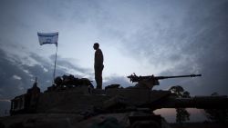 An Israeli soldier stands on his tank in a deployment area on November 22, 2012 on Israel's border with the Gaza Strip.
