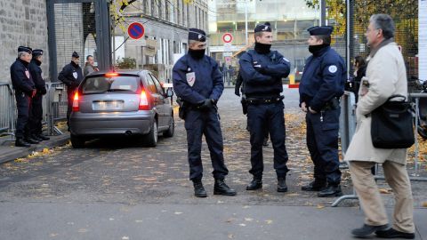 Policemen guard a Bordeaux courthouse where former French president Nicolas Sarkozy is due to appear.