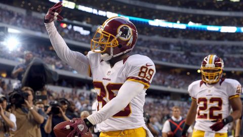 Santana Moss of the Washington Redskins celebrates a touchdown against the Dallas Cowboys during a Thanksgiving Day game on Thursday at Cowboys Stadium in Arlington, Texas. The Redskins defeated the Cowboys 38-31.