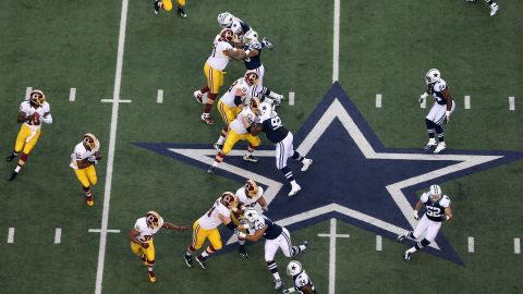 Robert Griffin III of the Washington Redskins, at left, looks to pass against the Dallas Cowboys.