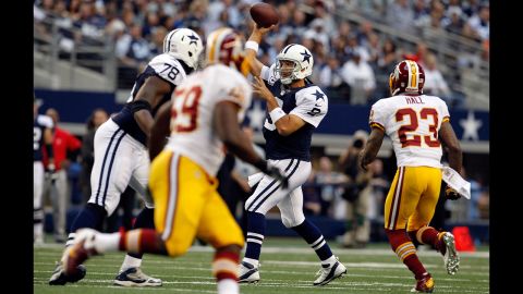 Cowboys quarterback Tony Romo fires a pass under pressure from the Redskins.