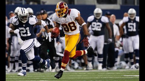 Pierre Garcon of the Redskins runs the ball for a touchdown against the Cowboys on Thursday.