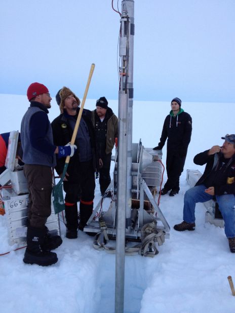 Scientists work the ice core drill in the middle of the inland ice.