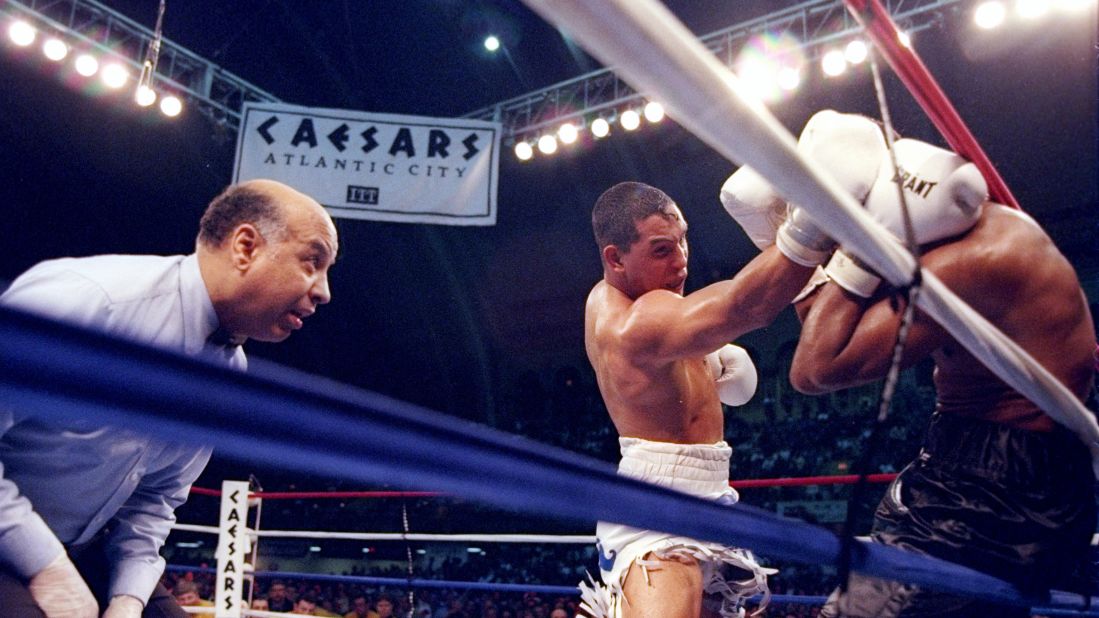 Camacho pins Sugar Ray Leonard to the ropes as referee Joe Cotez looks on during a bout in Atlantic City on March 1, 1997. Camacho won with a knockout in the fifth round, ending Leonard's comeback effort.