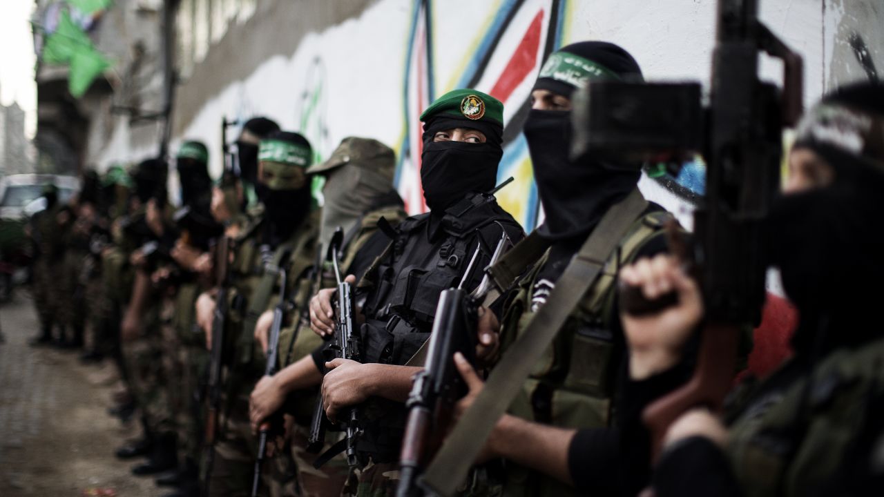 Hamas gunmen line up outside the house of their late leader Ahmed Jaabari in Gaza City on Thursday.