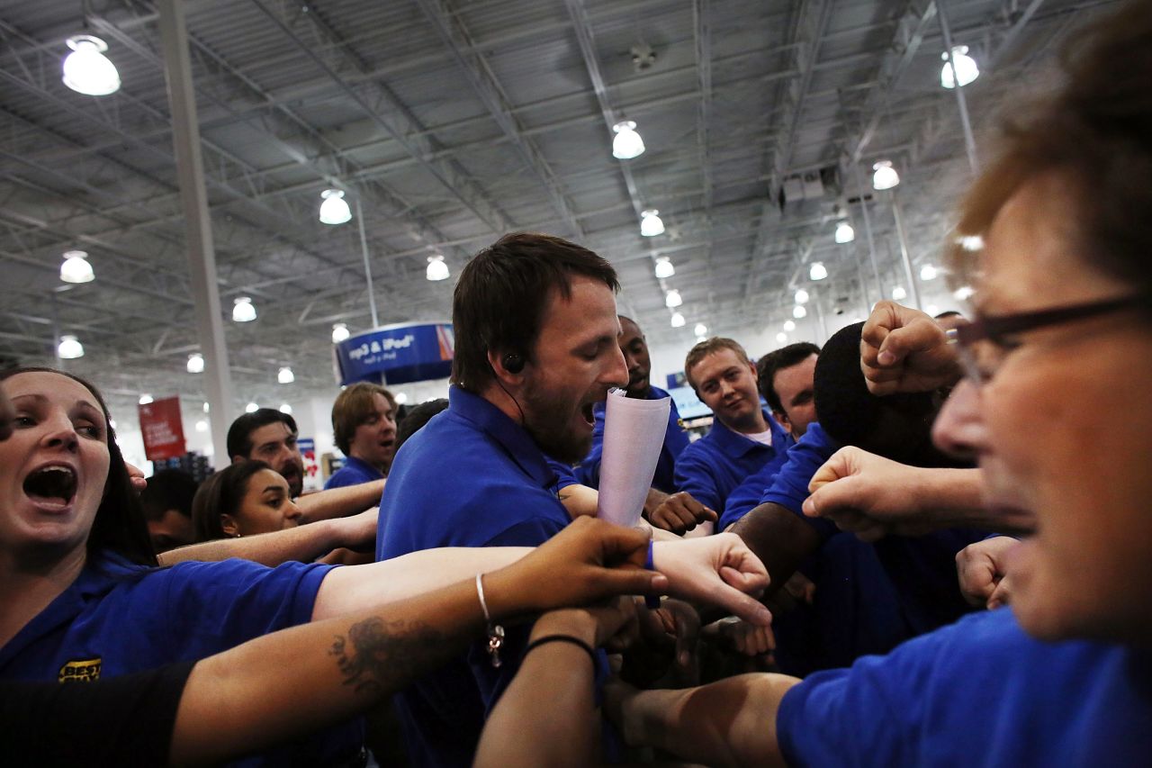 Best Buy employees have a group huddle before they open the store in Naples, Florida.