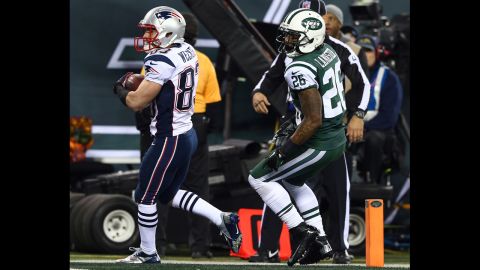 Wes Welker of the New England Patriots scores a touchdown past New York Jets defender Ellis Lankster.