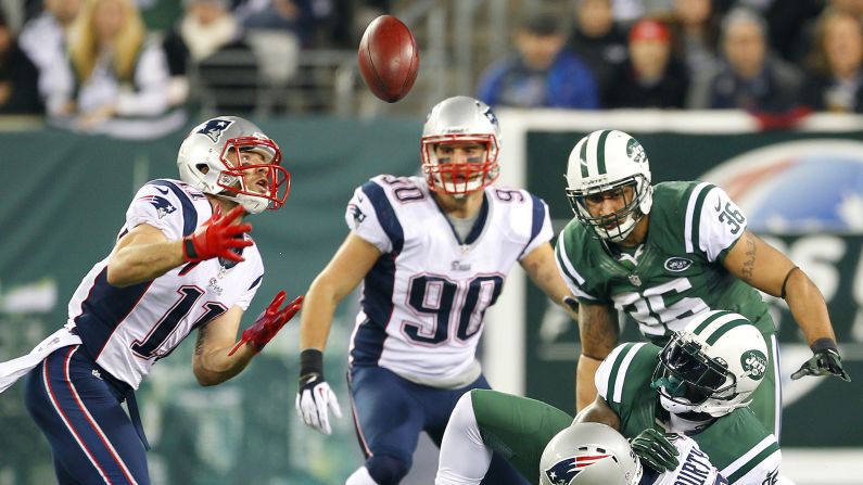 Julian Edelman of the New England Patriots looks to catch the ball after a fumble by No. 25 Joe McKnight of the New York Jets during the Thanksgiving Day game. Edelman scored a touchdown on the play.