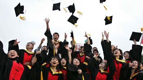 Students celebrate during their graduation ceremony at Shanghai Jiaotong University in June 2005. 