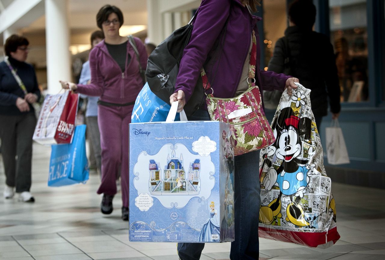 Shoppers carry bags during Black Friday sales at the South Shore Plaza in Braintree, Massachusetts. 