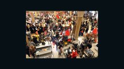 People crowd the first floor of Macy's department store as they open at midnight (0500 GMT) on November 23, 2012 in New York to start the stores' 'Black Friday' shopping weekend. AFP PHOTO/Stan HONDA (Photo credit should read STAN HONDA/AFP/Getty Images) 