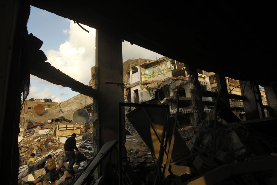 Palestinians inspect the rubble of a destroyed house in Gaza City on Friday.
