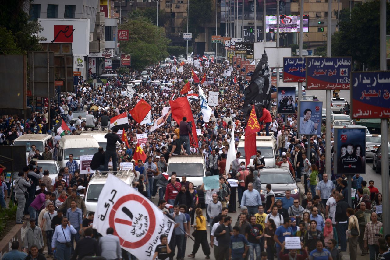 Thousands of demonstrators march through the streets of Cairo to protest against Morsy on Friday.