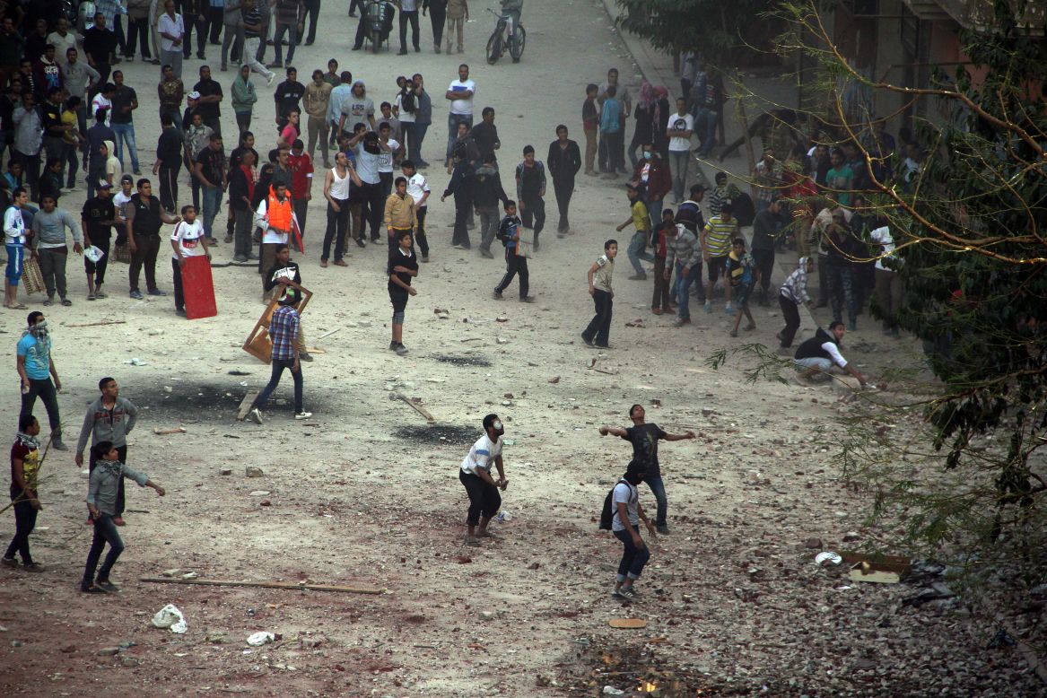 Egyptian protesters throw rocks toward riot police on Friday