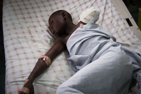 Twelve year old amputee Kakule Elie, hit by a stray bullet, lies in a bed in a hospital in Goma on November 20, 2012.
