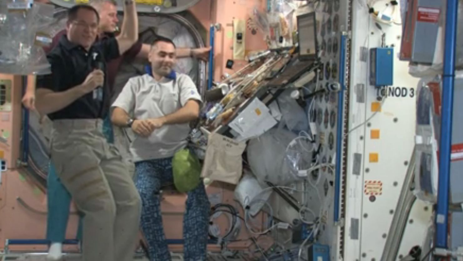 Space station crew members, from left, Kevin Ford, Oleg Novitskiy and Evgeny Tarelkin preview their Thanksgiving spread.