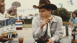 Larry Hagman eats on the set of the television soap opera "Dallas" in July 1979.