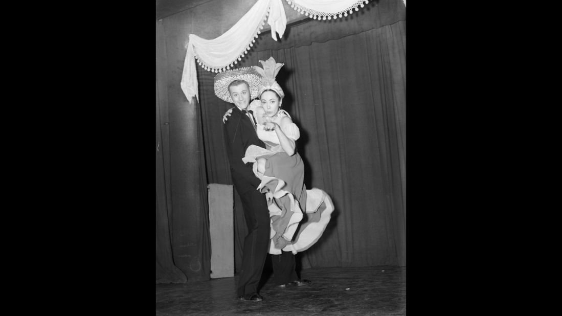 Hagman and actress Betta St. John wear exotic costumes during a stage show in 1952.