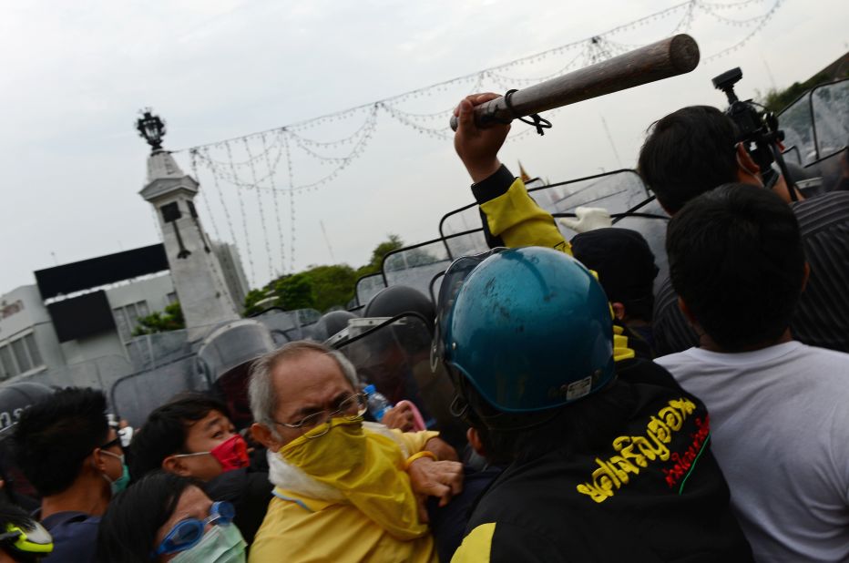 Demonstrators press toward police during a large anti-government protest on Saturday, November 24, in Bangkok, Thailand. The Siam Pitak group, which sponsored the protest, cited alleged government corruption and anti-monarchist elements within the ruling party as grounds for the protest. Police used tear gas and baton charges againt protesters. 