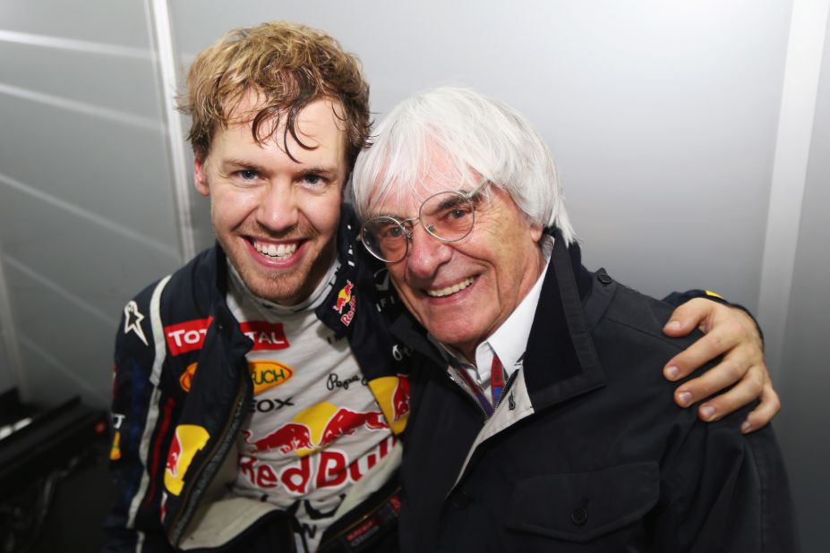 Vettel celebrates with Formule One supremo Bernie Ecclestone following his title win in Brazil.