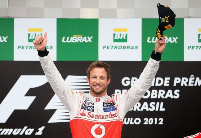 Button salutes the crowd at Interlagos following his victory. He said: "First of all I want to congratulate the whole team. This is  the perfect way to end the season. We have had ups and downs and to end on a  high bodes well for 2013."