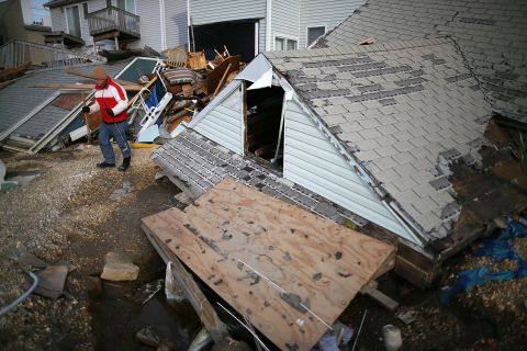 David McCue stands near the roof of his beach house, which was completely demolished by Superstorm Sandy, in Ortley Beach, New Jersey, on Sunday, November 25. <a href="http://www.cnn.com/2012/10/30/us/gallery/sandy-damage/index.html" target="_blank"><strong>See photos of the immediate aftermath of Sandy.</strong></a>