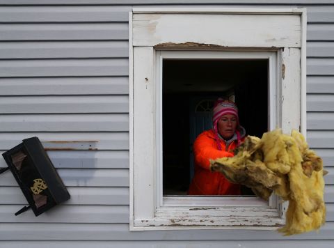 Rena McCain cleans out the first floor of her home in Seaside Heights on Sunday.